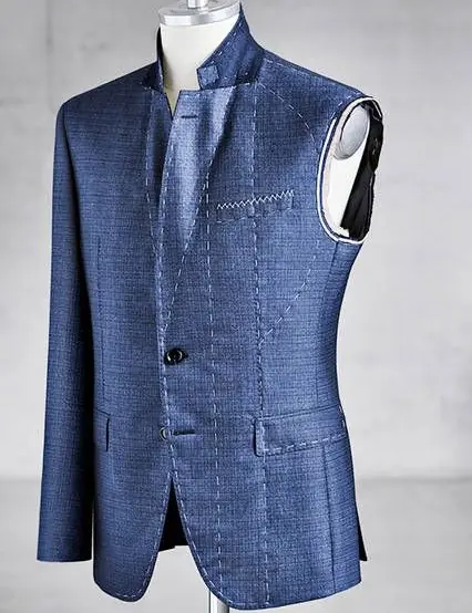 A jacket at the basted stage: one sleeve on, the canvas still showing.
