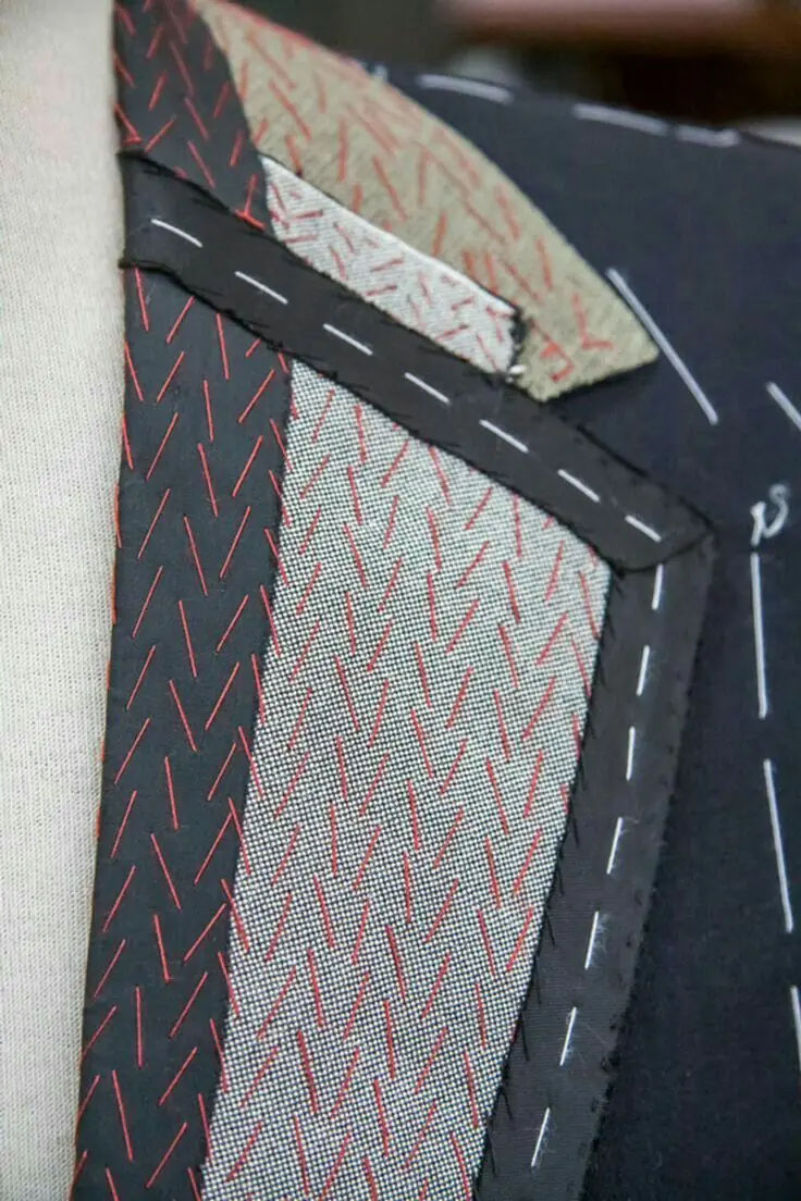 The underside of a lapel: hair canvas pad-stitched by hand, basting still in.